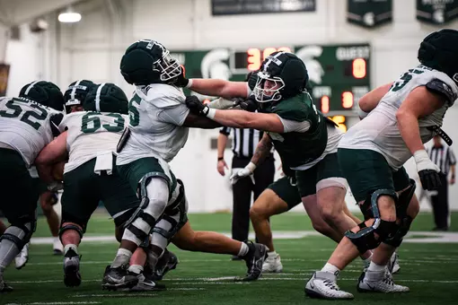 The Michigan State football team conducts a team drill during spring practice in March 2026.