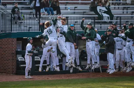 Noah Bright and Randy Seymour, and the MSU dugout celebrate a home run.