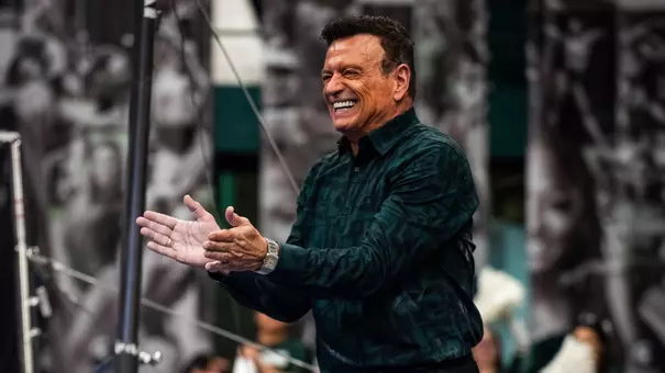 Michigan State head gymnastics coach Mike Rowe celebrates after a routine