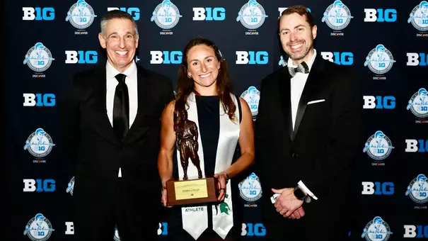 Maddie Lawlor is presented with the national Jackie Robinson Award by Big Ten Commissioner Tony Petitti and J Batt at the MSU Academic Gala