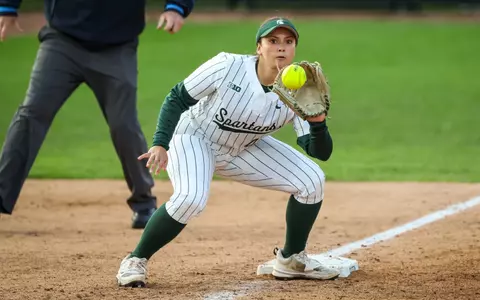 Hannah Hawley catches the ball at third base to apply the tag on a stealing runner against Illinois