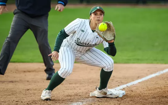 Hannah Hawley catches the ball at third base to apply the tag on a stealing runner against Illinois