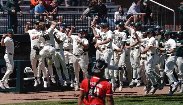 Noah Bright and team celebrate outside dugout
