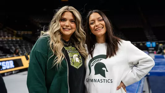 MSU gymnastics coaches Nicole Jones and Devin Wright stand for a photo