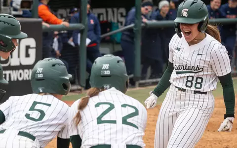 Sophie Holverstott is greeted by teammates at home plate