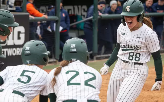 Sophie Holverstott is greeted by teammates at home plate