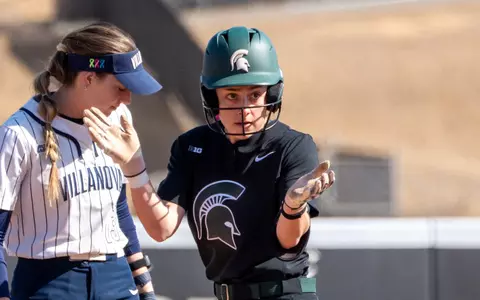 Hannah Greer celebrates after a base hit