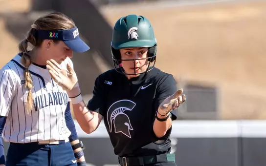 Hannah Greer celebrates after a base hit