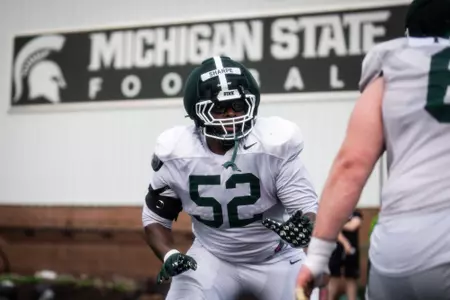 Nick Sharpe goes through a drill during spring practice for the Spartans.
