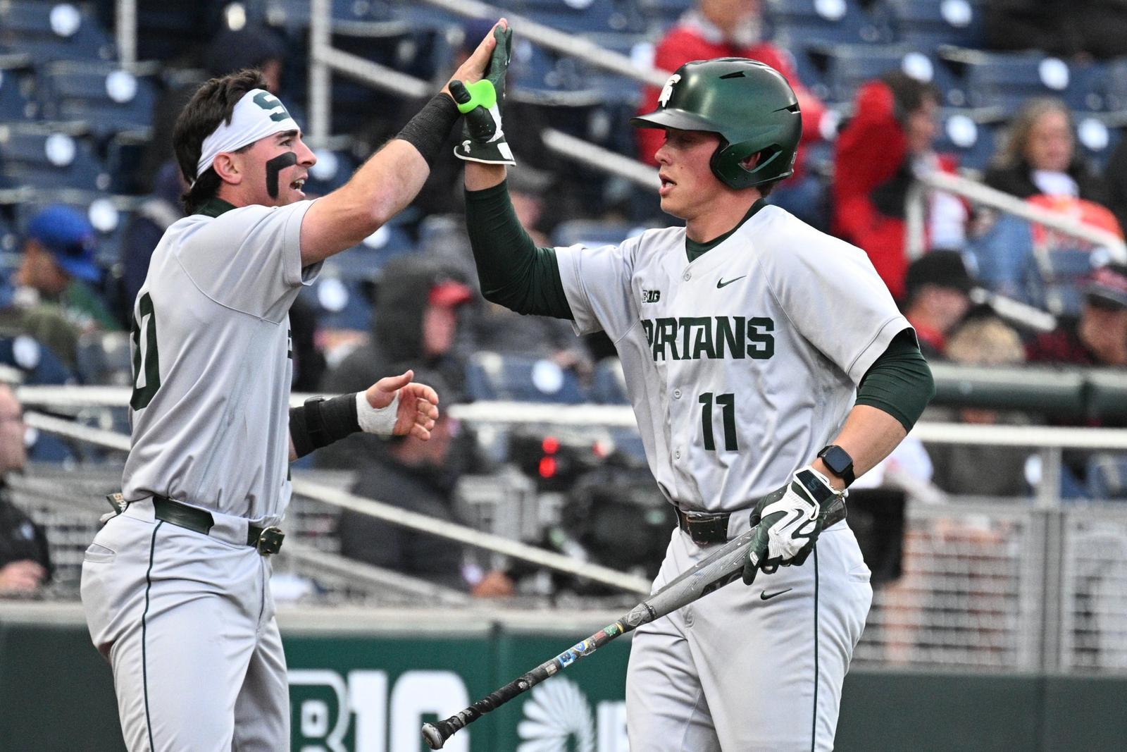 Nick Williams and Parker Picot high five during Michigan State's win over Iowa at the Big Ten Tournament in Omaha, Neb.