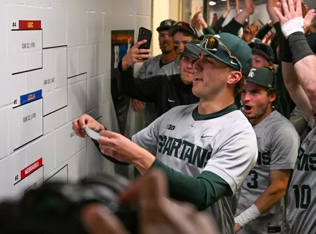 Nolan Higgins applies Michigan State's sticker to the 2026 Big Ten Baseball Tournament after the Victory for MSU over Iowa on May 20, 2026.