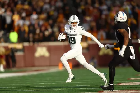 Charles Taplin runs with the ball at Minnesota in his collegiate debut in 2025.