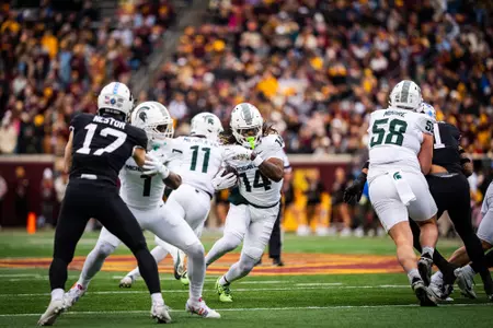 Bryson Williams runs through the hole during a game at Minnesota in 2025.