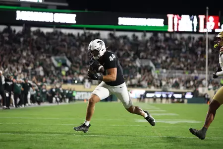 Jay Coyne scores a touchdown in overtime against Boston College at Spartan Stadium in 2024.