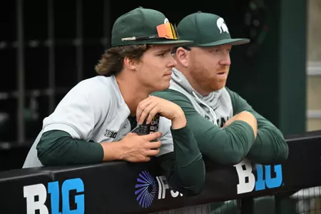Coach Gelly and Cole Van Ameyde in dugout during Michigan State vs Iowa game at the Big Ten Tournament in Omaha, Neb.
