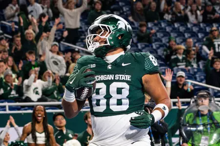 Kai Rios scores a touchdown against Maryland at Ford Field in 2025.