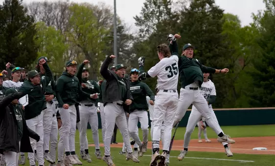 Randy Seymour and Josh Klug celebrate with the dugout after Seymour hit a home run.