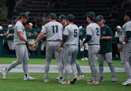 Andrew Siler is greeted by teammates returning to the dugout between innings during game at Eastern Michigan on March 10, 2026.