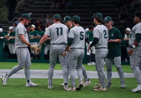 Andrew Siler is greeted by teammates returning to the dugout between innings during game at Eastern Michigan on March 10, 2026.