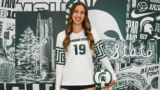 Hayley Ogden stands with a volleyball