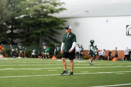 Pat Fitzgerald walks the field during a practice at preseason camp.
