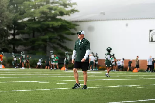 Pat Fitzgerald walks the field during a practice at preseason camp.