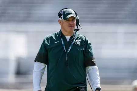 Pat Fitzgerald walks the field during a spring practice in Spartan Stadium.