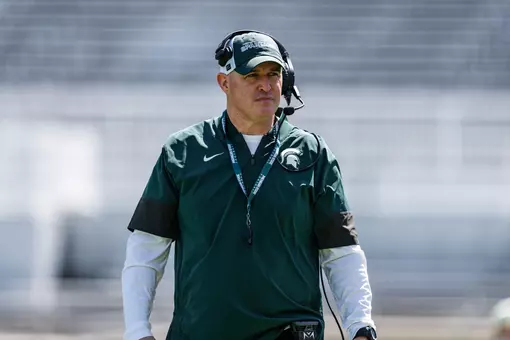 Pat Fitzgerald walks the field during a spring practice in Spartan Stadium.