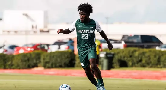 Leo Conneh dribbles the ball down the field.