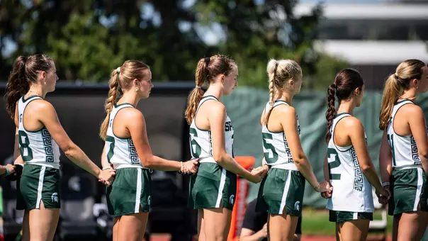 Field Hockey team pauses for the National Anthem pre-game