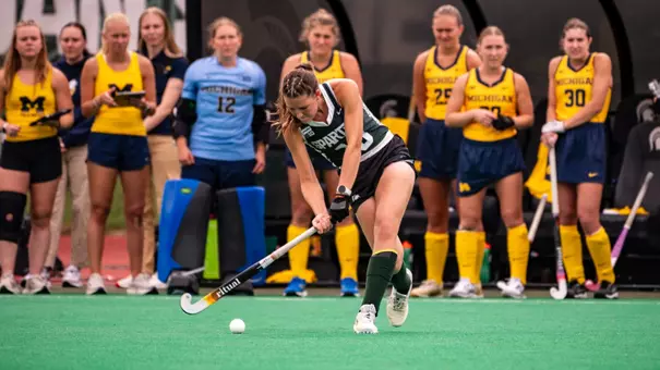 Caro Schafer hits the ball against Michigan at Ralph Young Field