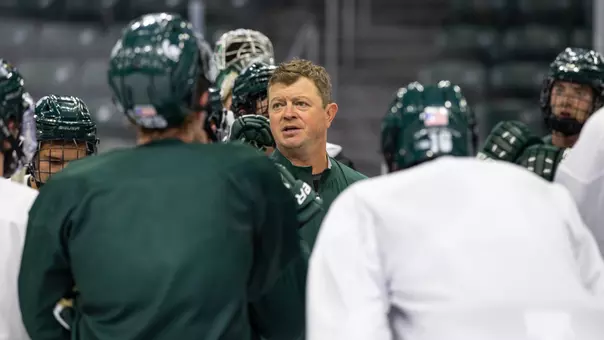 Head Coach Adam Nightingale speaks to the team at practice