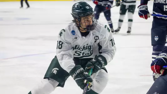 Ryker Lee controls the puck near the boards against UConn in the NCAA Tournament