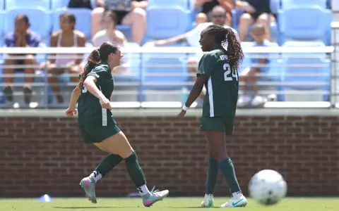 Kayla Briggs and Kennedy Bell celebrate a goal at North Carolina