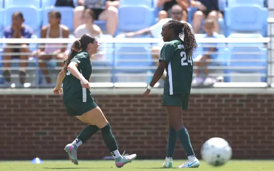 Kayla Briggs and Kennedy Bell celebrate a goal at North Carolina