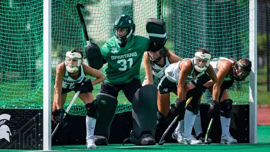 Field Hockey team lines up to defend a penalty corner against #15 Louisville