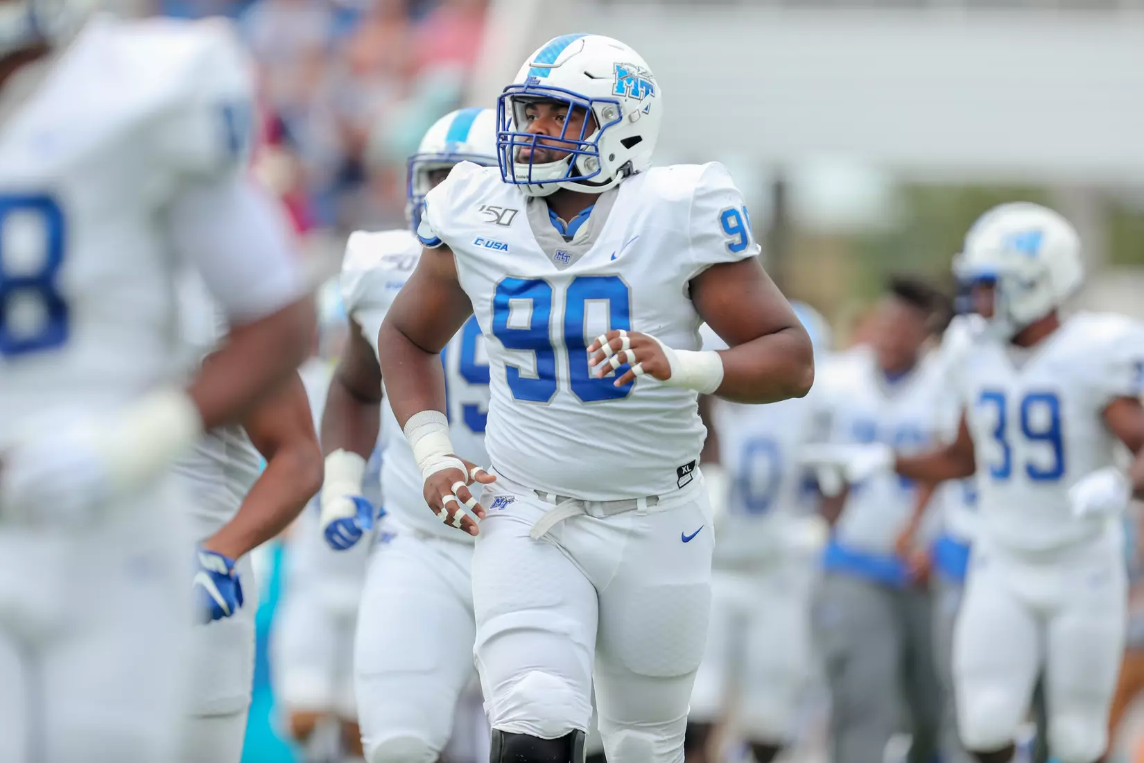 Poydras jogging on field