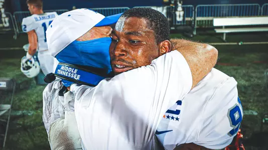 Jordan Ferguson and Coach Stockstill hugging