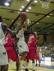 Mike Dean (15) drives to the b...