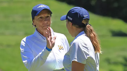 Coach Velvet Milkman and Linette Holmslykke at the NCAA Women's Golf Championship at Blessings Golf Club in Fayetteville, Arkansas.