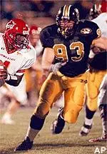 Iowa State quarterback<br>Derrick Walker tries<br>to get around<br>Missouri's Jeff Marriot<br>during the first<br>quarter Saturday.