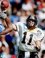 Quarterback Jim Dougherty<br>passes over the<br>outstretched arms of<br>Memphis defensive end<br>Tramont Lawless in the<br>first half Saturday.