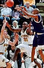 Western Carolina's Ricky Gandy, right, tosses a pass over Missouri's Johnnie Parker (31) and Brian Grawer, left, during Missouri's 85-68 victory on Sunday.