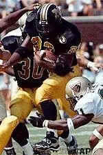 Missouri's DeVaughn Black runs<br>past UAB defenders during<br>Mizzou's 31-28 win, Saturday.