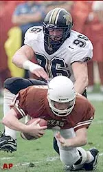 All-American candidate Justin Smith greats Major Applewhite with a sack on Saturday afternoon.