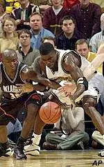 Oklahoma State's Joe Adkins battles Missouri's Tajudeen Soyoye for a loose ball Monday.