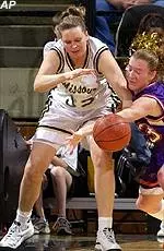 Missouri's Melissa Statham fends off Evansville's Lisa Eckart while chasing a loose ball.