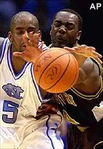 North Carolina's Ed Cota and Missouri's Clarence Gilbert reach for a loose ball during the Tigers' 84-70 loss, Friday.