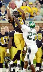 Missouri receiver Justin Gage, left, leaps over Michigan State safety Duran Bryan, right, to make a catch during the first quarter.