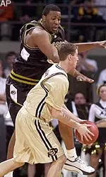 Colorado guard Nick Mohr, front, looks to pass the ball as Missouri center Arthur Johnson comes in to cover in the first half in Boulder, Colo., Wednesday.